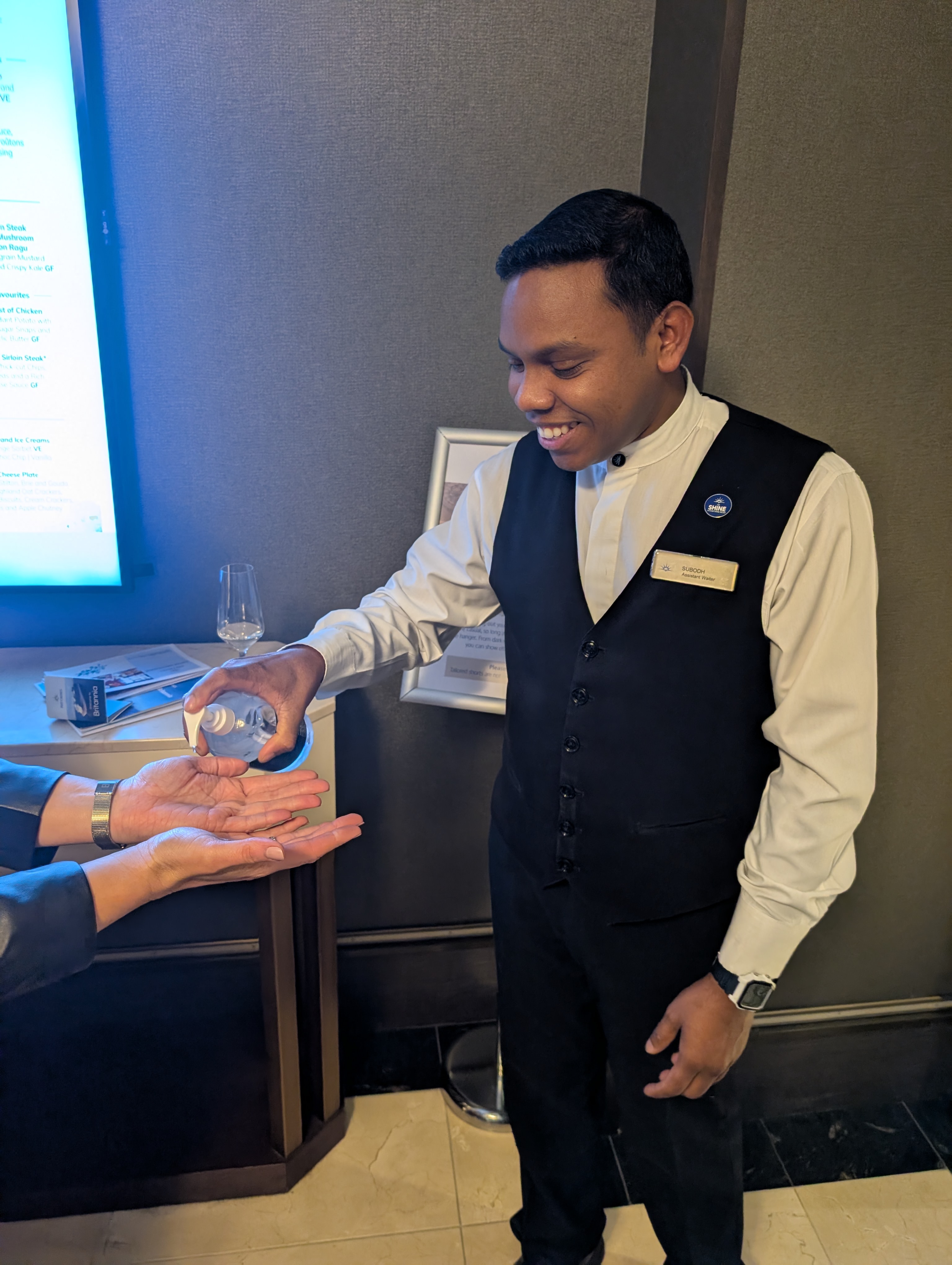 Hand sanitising going into Peninsula restaurant on P&O Britannia
